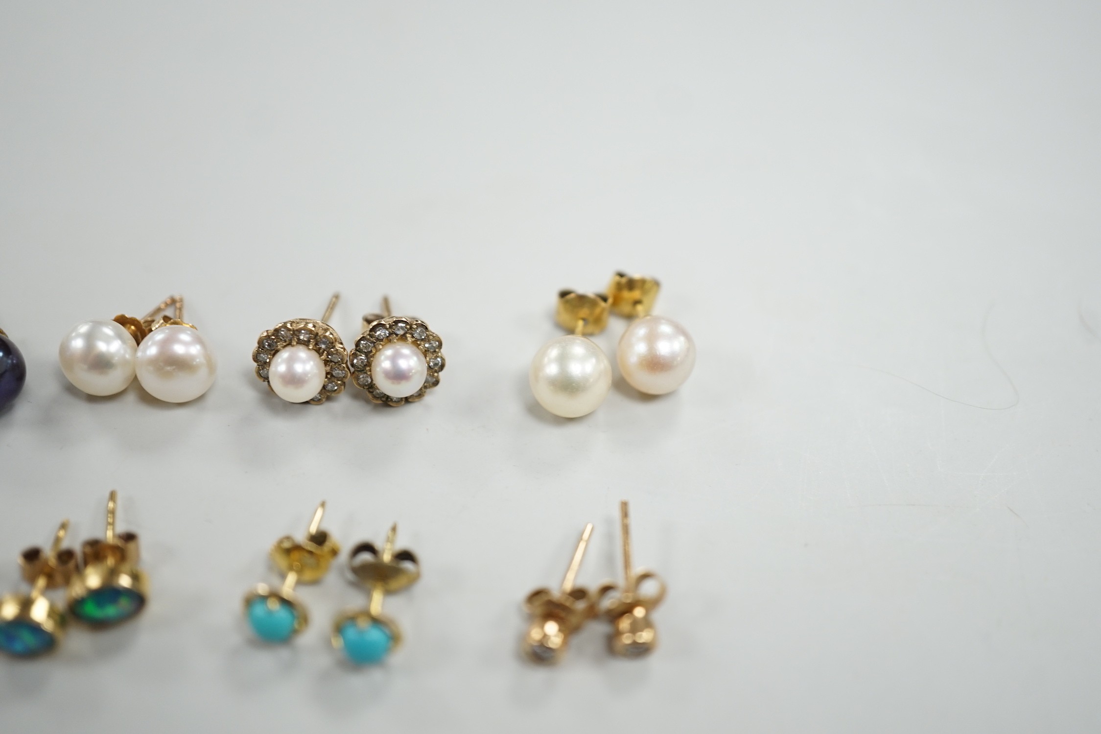Eight assorted modern pairs of ear studs, including a 14k and cultured pearl and two other cultured pearl, one 9ct and diamond chip.
